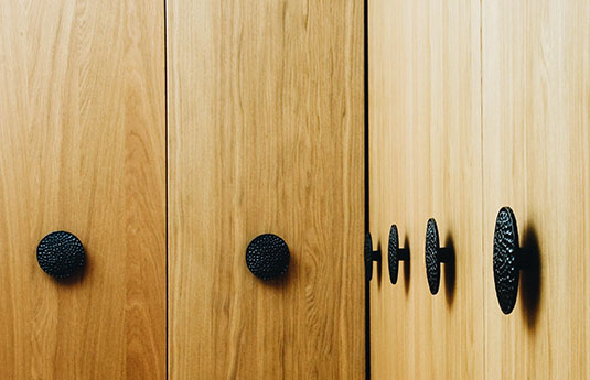 Du Veere door pulls on a wood cabinet