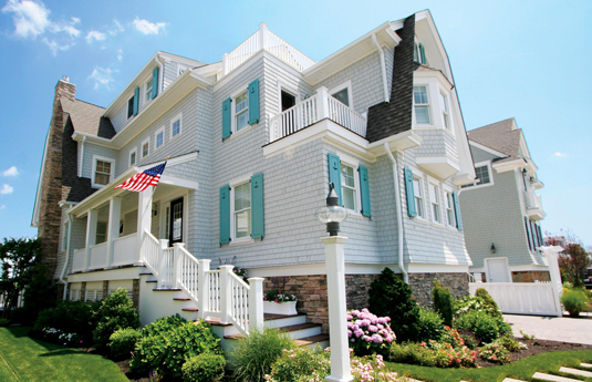 atlantic-shutters-1 light blue shtters on a gray house